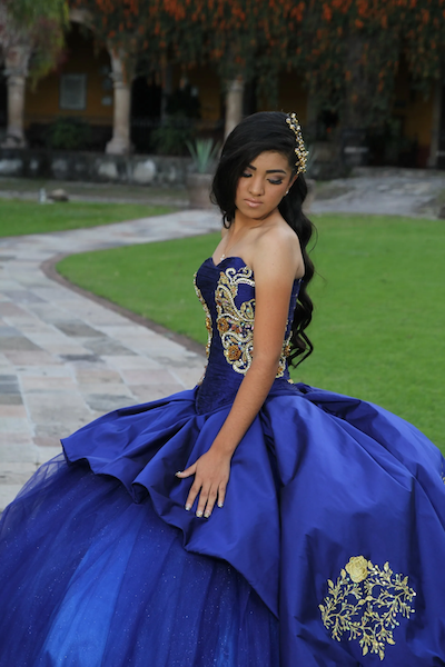Photo of a women in her blue Quinceañera dress.
